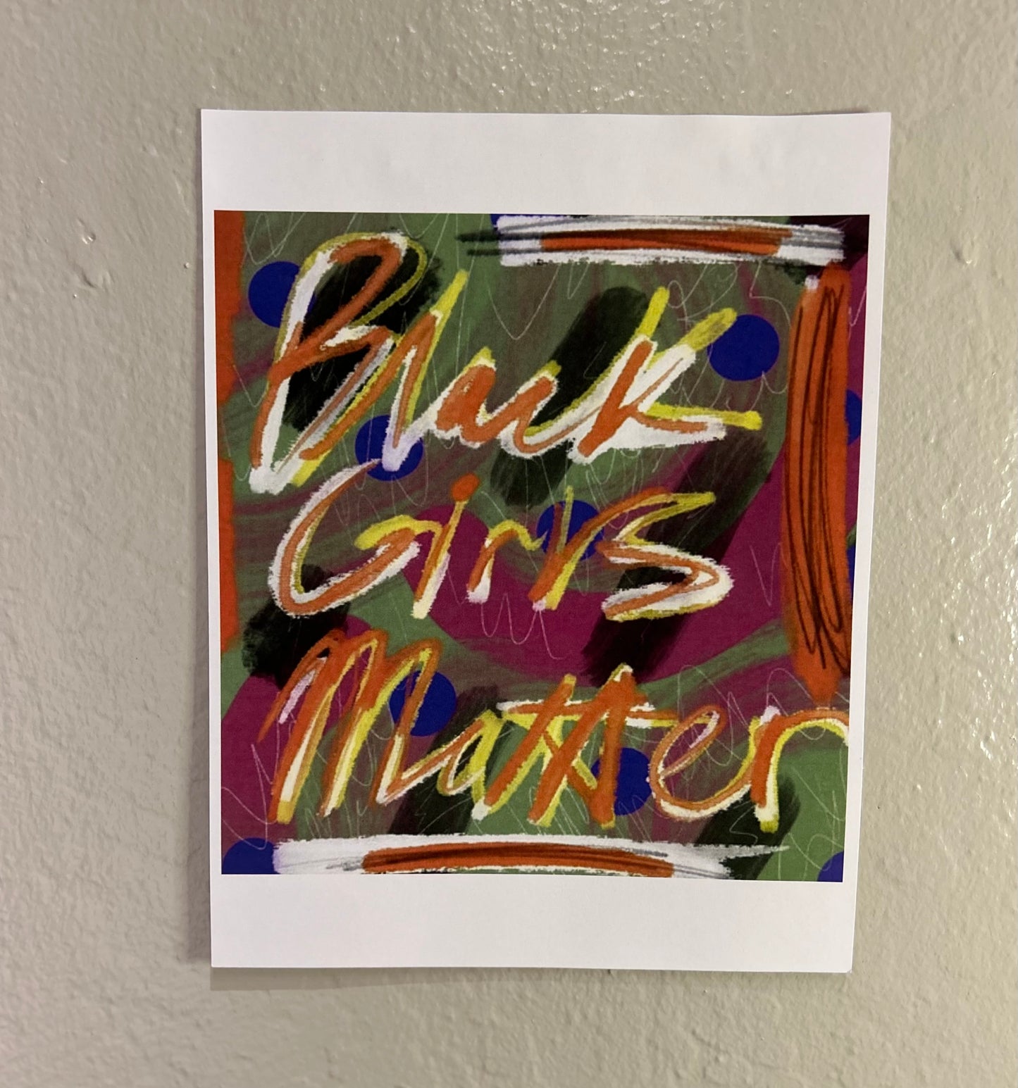 Photo of art print by blackgirlsaregod "Black Girls Matter" hanging frameless on a wall.